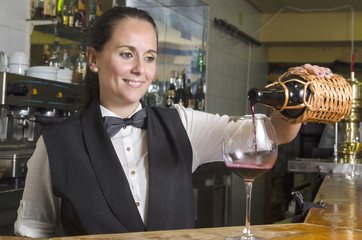 waitress serving red wine