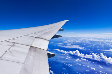 Fototapeta premium Air plane wing above the cloud and sea