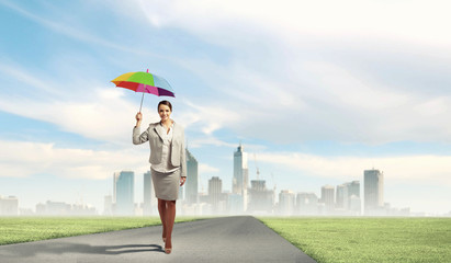 Young business woman holding an umbrella