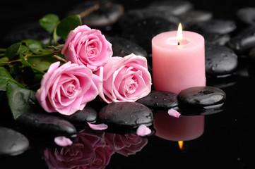 Pink rose with black stones and candle