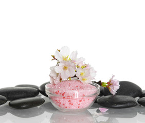 Obraz na płótnie Canvas Cherry blossom branch with salt in bowl and therapy stones