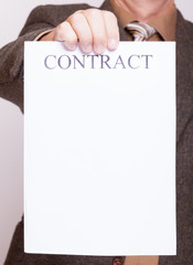 Businessman holding blank paper with sign contract