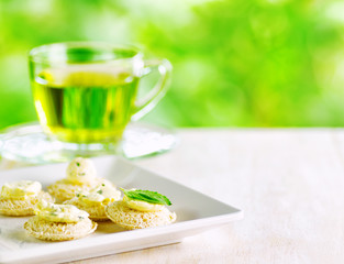 Several canapes and cup of herbal tea.