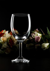 empty wine glass and roses