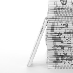Phone and Newspapers folded and stacked concept