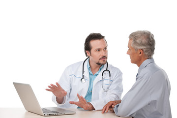 Adult doctor talking to old patient.