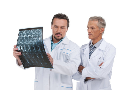 Two experienced doctors discussing X-ray.