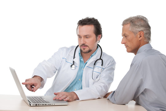 Doctor  showing on laptop test results to his patient.