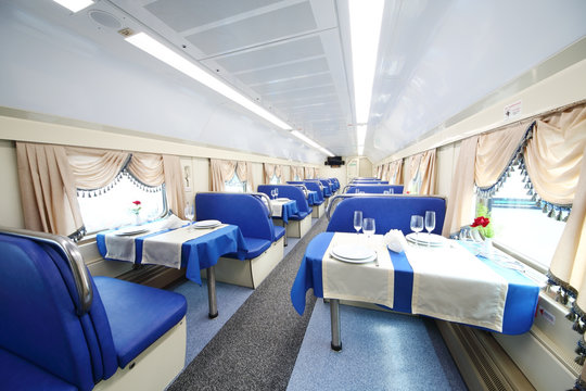 The interior of the restaurant car with covered tables