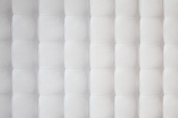 Wall with white quilted pattern consisting of equal squares