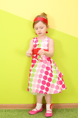 A little girl in a bright varicolored dress