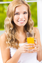 Happy woman drinking juice