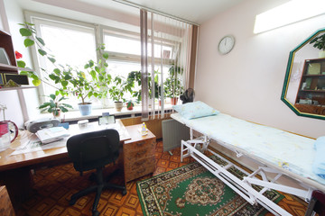 Interior of a light doctors consulting room with a bed