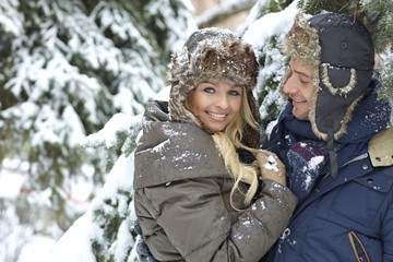 Fototapeta na wymiar Loving couple embracing in winter forest