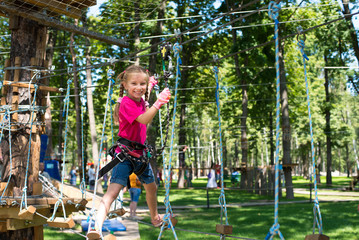 little girl  in a rope park