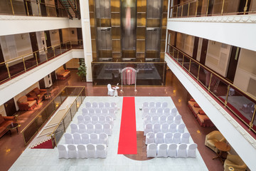 hall for wedding ceremony with decorated chairs