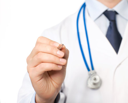 hand of doctor in a white coat with a stethoscope holding a pen