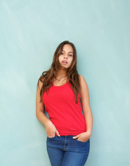 Relaxed young woman standing indoors with hands in pocket