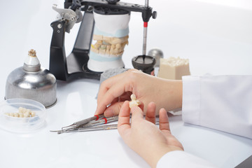 Dental technician working with articulator in dental laboratory © pixs4u