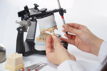 Dental technician working with articulator in dental laboratory © pixs4u