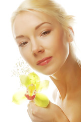 beautiful blond woman with green orchid flower