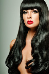 Fototapeta premium brunette with long hair and red lipstick