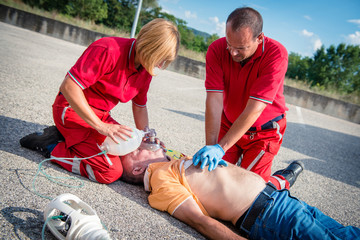Paramedics succor a man with heart attack