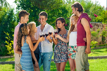 Teenagers celebrating a toasting with wine.