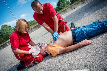 Paramedics succor a man with heart attack