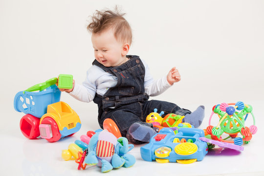 Happy Baby Playing With Toys White Background