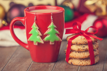 Cookies, cup of coffee with christmas gifts at background