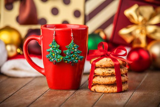 Cookies, cup of coffee with christmas gifts at background