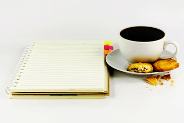 cup of coffee with cookie and notebook isolated on white backgro