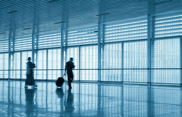 passengers motion blur in modern corridor