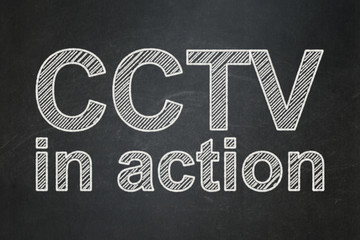 Security concept: CCTV In action on chalkboard background