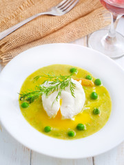 Fresh soup from green peas and egg-poached