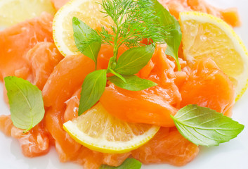 fresh salmon with lemon on the white plate
