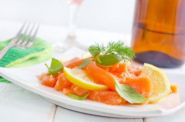 fresh salmon with lemon on the white plate