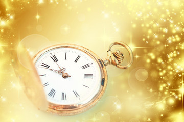 Gold clock showing midnight