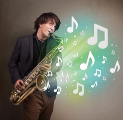 Young musician playing on saxophone while musical notes explodin