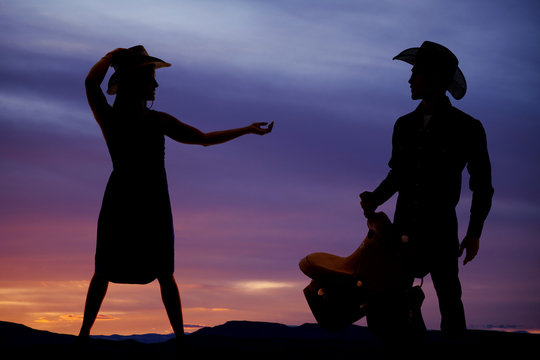 silhouette woman cowgirl hand out