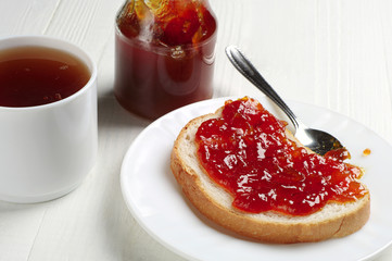 Piece of bread with jam and tea