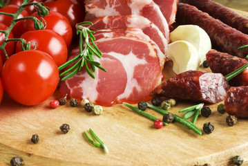Sliced Smoked Ham and Smoked sausage with rosemary