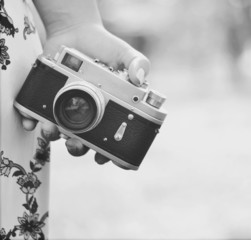 Close up of woman hand holding retro camera