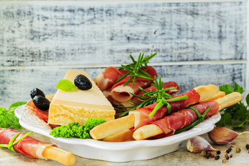 Italian prosciutto di Parma, grissini, Grana Padano
