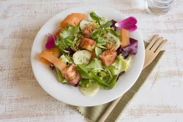 Fresh salad greens, wooden fork