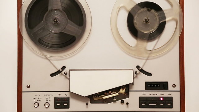 old reel tape recorder with spinning reels