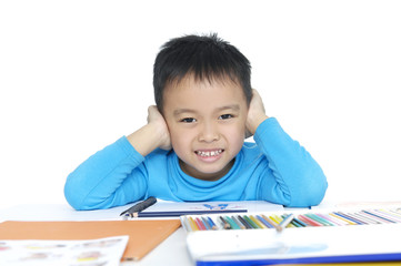 Portrait of a schoolboy sitting at table with books
