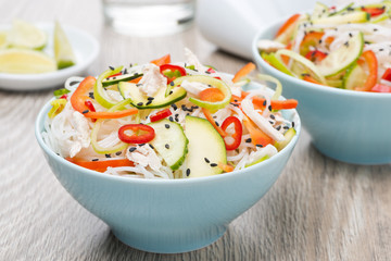 delicious Thai salad with vegetables, rice noodles and chicken i