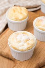 peach souffle in the portioned form on a wooden board, vertical